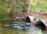 Motorcyclist clips camper, ends up in Deer Lick Creek