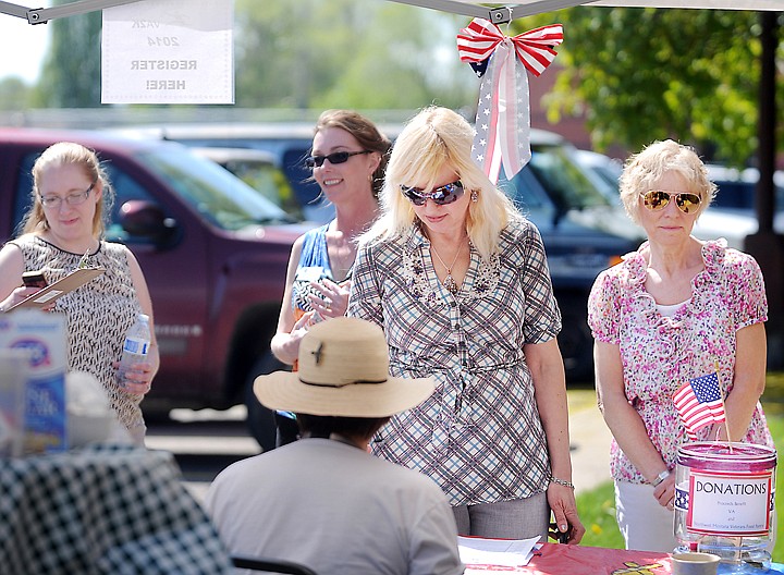 &lt;p&gt;Valeriya Voronina, center, and Jane Wright, right, sign up for the Veterans Affairs 2K Walk and Roll on Wednesday in Kalispell. Karen Blackbird of the Kalispell Veteran Affairs Clinic said one of the goals of the event is to raise awareness of homelessness within the veteran population.&lt;/p&gt;