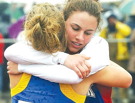 Bigfork High School's Brooke Andrus, right, embraces Fergus High School's Emmy Bentley after their race in the Class A 800-meter run Saturday in Butte. Andrus took first place and Bentley took second. Bentley last year ran for Class B Eureka. Associated Press