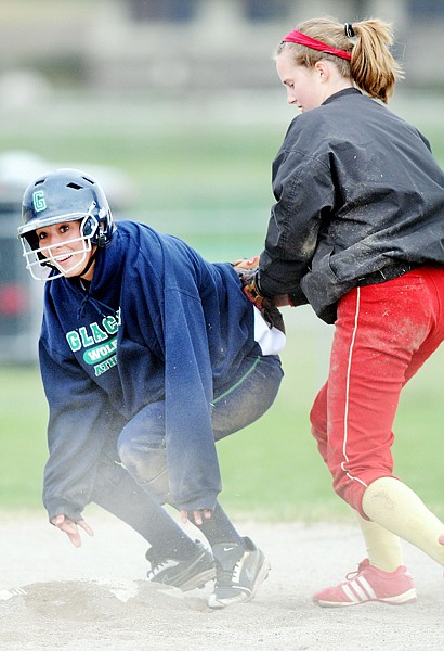 Glacier's Bryttani Knopp, 12, slides safely into second base on Thursday, April 22. She went on to reach home scoring the first run of the game against Hellgate.