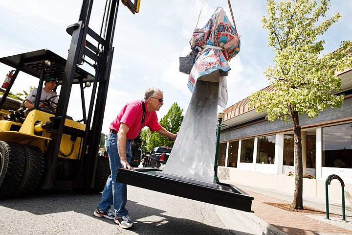 &lt;p&gt;SHAWN GUST/Press Artist Richard Warrington, of Spokane, steadies his sculpture &quot;Save The Children&quot; Wednesday prior to installation of the piece on Third Street in Coeur d'Alene. The art is part of the Coeur d'Alene Arts Commission's Art Currents Project where 15 artworks will be on load from the artists around the city for one year. Each piece is available for sale as a way to support area artists.&lt;/p&gt;