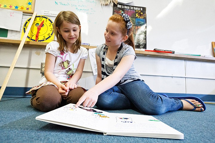 &lt;p&gt;SHAWN GUST/Press Canfield Middle School sixth-grader Madi Wilkinson shares a book she made for Kinsley Finch, a second-grader at Bryan Elementary School, left, as three classes from each school met with their pen pals Wednesday. The pen pals program in its eight year, is aimed at teaching second-graders letter writing skills while creating relationships with other local students.&lt;/p&gt;