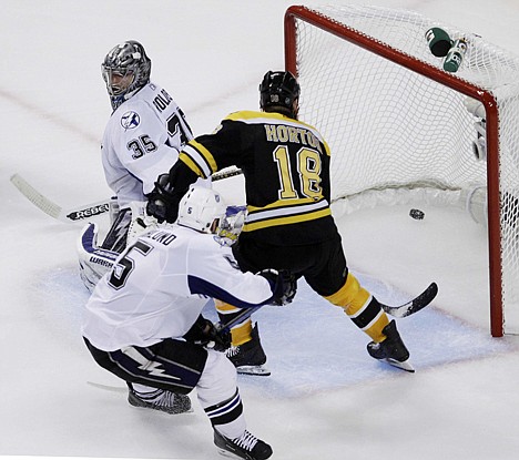 &lt;p&gt;Boston's Nathan Horton (18) slips behind Tampa Bay's Mattias Ohlund and one-times a pass past goalie Dwayne Roloson (35) during the third period in Game 7 of the Eastern Conference finals Friday night. The Bruins beat the visiting Lightning 1-0 to win the series 4-3 and advance to the Stanley Cup finals where they will meet the Vancouver Canucks.&lt;/p&gt;