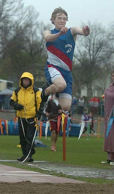 Photo by Trent Makela Bobcat Tyler Stenberg soars through the rain to capture the State C championship in the triple jump. Stenberg jumped 43 feet and 3/4 of an inch.