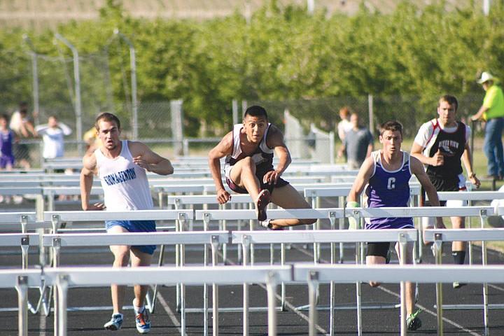 Wahluke's Rafa Mendoza skims over the barriers to take first place in the 300-meter hurdles at the South Central A Conference East sub-district track meet at Wahluke High School last Thursday. As expected, his stiffest challenge came from Laddie Goroski in second place.