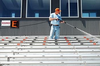 Dale Berman washes the bleachers at Legends Stadium on Wednesday afternoon. Approximately 5,000 to 6,000 people are expected to attend the Class AA and B track meets Friday and Saturday at Legends. Nate Chute/Daily Inter Lake