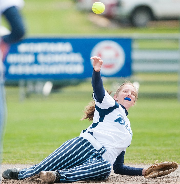 <p>Patrick Cote/Daily Inter Lake Great Falls shortstop Jessica Keller throws to first base during the Bison's win over Missoula Sentinel Thursday afternoon during the first round of the 2012 State Class AA softball tournament at Kidsports Complex in Kalispell. Thursday, May 24, 2012 in Kalispell, Montana.</p>
