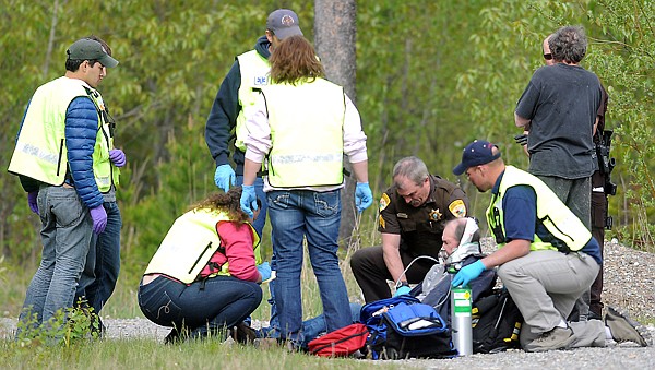 &lt;p&gt;Sergeant Kevin Burns of the Flathead County Sheriff's Office, center, and other emergency responders at the scene of a reported shots fired on Belton Stage Road in West Glacier, on Saturday evening, May 26.&lt;/p&gt;