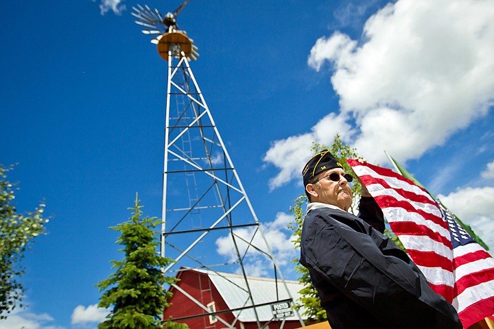 &lt;p&gt;JEROME A. POLLOS/Press Bill Glasco, an American Legion Post 14 member, holds an American flag that was raised at the Meadow Ranch neighborhood Friday in Coeur d'Alene. Glasco worked at the barn that is the centerpiece of the Meadow Ranch development in the 1940's as a teenager.&lt;/p&gt;