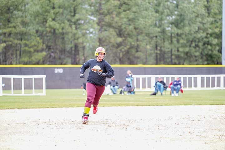 Jazymnn Jesse is all smiles as she rounds second base after hitting a two-run home run against Woodinville in the first inning of game two of the state tournament.