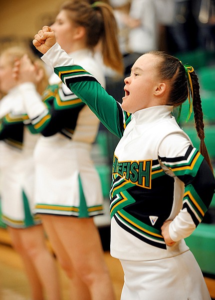 Cedar Vance, a senior at Whitefish High School and members of the cheerleading team cheer during the Whitefish/Ronan game on Thursday, Feb 25, during the Northwestern Class A Divisional Program. Whitefish won the game 36 to 30.