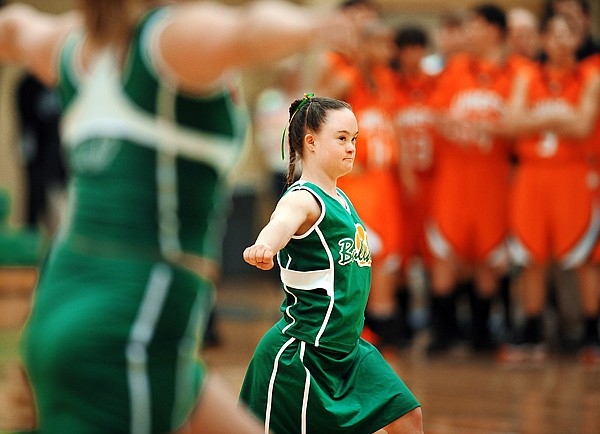 Cedar Vance, a senior at Whitefish High School and members of the cheerleading team cheer during the Whitefish/Ronan game on Thursday, Feb 25, during the Northwestern Class A Divisional Program. Whitefish won the game 36 to 30.