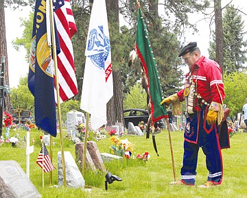 &lt;p&gt;Veteran Warrior Society member Bill Rogers reflects at Laverne Parrish's gravestone in Ronan on Monday. Parrish received the Medal of Honor for his service in World War II.&lt;/p&gt;