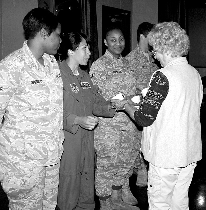 Rita Mayrant hands a Grant County Historical Society coffee mug to Major Christine Stanaback, prompting a thank-you hug from the Major.