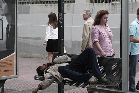 &lt;p&gt;An immigrant sleeps at a bench of a bus stop in central Athens on Tuesday May 29, 2012. The four biggest Greek banks received 18 billion euros (22.6 billion USD) in rescue funds on May 28, 2012 to help reinforce their capital bases, a Hellenic financial stability fund source said. National Bank, the biggest Greek lender, has received 7.43 billion euros, Piraeus bank 4.7 billion, Eurobank 3.97 billion and Alpha 1.9 billion, the official said.(AP Photo/Dimitri Messinis)&lt;/p&gt;