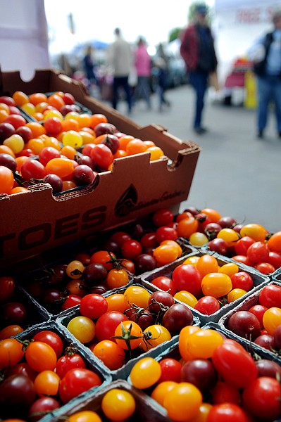 <p>Boxes of tomatoes are on display at the Mountainview Gardens booth at the Kalispell Farmers Market on Saturday, May 26.</p>