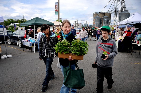 &lt;p&gt;From left, Alice Lesowski of Eureka and Toni and Sean Mickow of Kalispell stroll through the Kalispell Farmers Market on Saturday, May 26.&lt;/p&gt;
