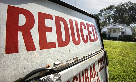 &lt;p&gt;A home sits for sale with a reduced price sign, in Bedford Hts., Ohio, Thursday, May 27, 2010. Mortgage rates have fallen to the lowest level of the year as European turmoil caused investors to pour money into the safe haven of U.S. government securities. (AP Photo/Amy Sancetta)&lt;/p&gt;