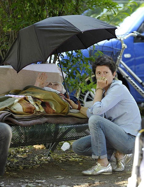 &lt;p&gt;A woman holds an umbrella to make shade for an elderly woman laying on a bench after she was evacuated from a nearby hospital, in Mirandola, northern Italy, on Tuesday, May 29, 2012. A powerful earthquake killed at least 15 people and left 200 injured Tuesday as it rocked a swath of northern Italy hit just nine days ago. Factories, warehouses and churches collapsed, dealing a second blow to a region where thousands remained homeless from the previous, stronger temblor . The 5.8 magnitude quake left 14,000 people homeless in the Emilia Romagna region north of Bologna, one of Italy?s most agriculturally and industrially productive areas. (AP Photo/Marco Vasini)&lt;/p&gt;