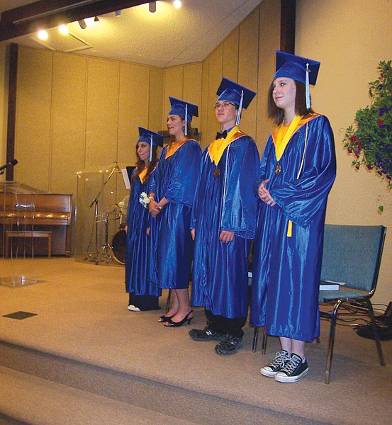 Karina Thomas, Dillon Fitzpatrick, Joshua-Luke O'Connor and Lynzi Lapka stand during their graduation ceremony.