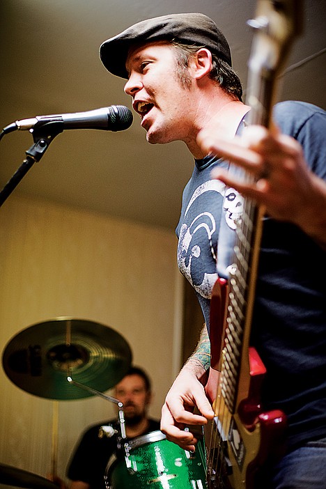 <p>Ryan White provides back up vocals while plucking the baseline during a recent Scatterbox rehearsal.</p>