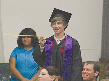 &lt;p&gt;Cody Kobilansky holds the other end of graduation speaker Christina Madsen's measuring tape from the back of the gym.&lt;/p&gt;