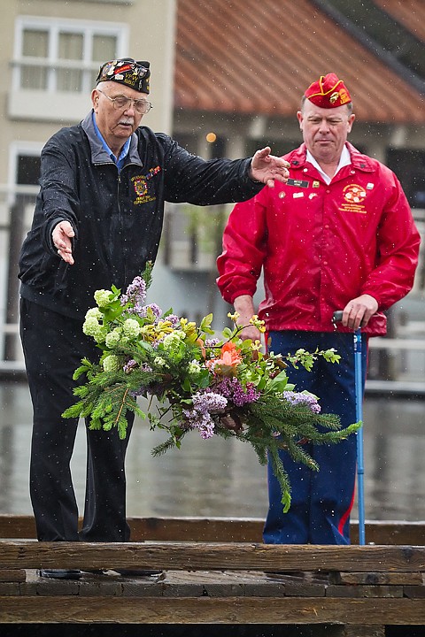 <p>Jim Shepperd, past commander with the Veterans of Foreign Wars Post 889, tosses a wreath into Lake Coeur d'Alene Monday to honor veterans who have lost their lives at sea during Memorial Day services at the Third Street boat launch. Accompanying Shepperd is Randy Weiss, with the Uniteds States Marine Corps League, Pappy Boyington Detachment 966.</p>