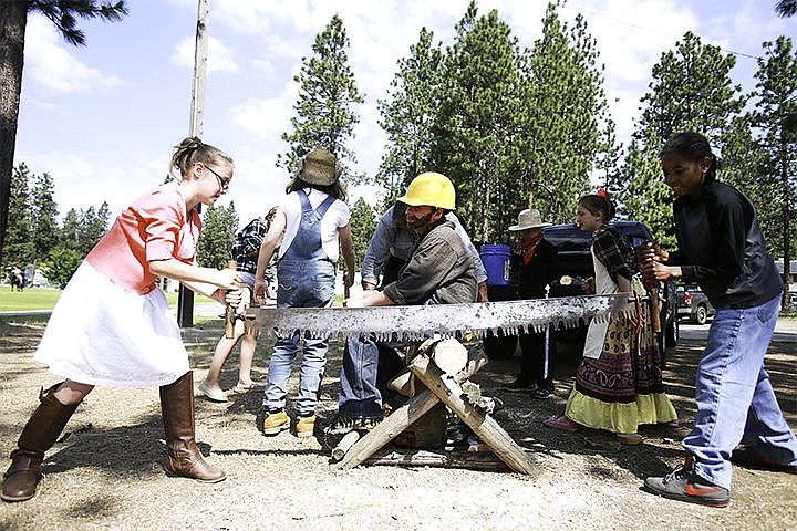 &lt;p&gt;Eden Harrison, 9, left, and Aidell Arch,10, work together to saw a log to experience some of Idaho&#146;s logging history at the Ponderosa Elementary Rendezvous.&lt;/p&gt;