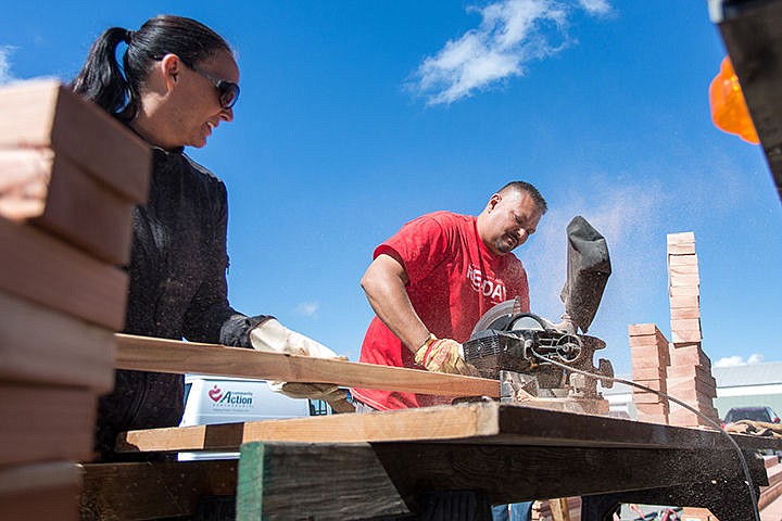 &lt;p&gt;Sean Siroshton, of North Idaho Title, cuts a length of wood for new garden beds with the help of Tambra Pickford. Over 30 members of the community gathered at Community Action Partnership to make garden beds, install a sprinkler system, paint, make a recipe wall and many other tasks at the Coeur d'Alene food bank.&lt;/p&gt;