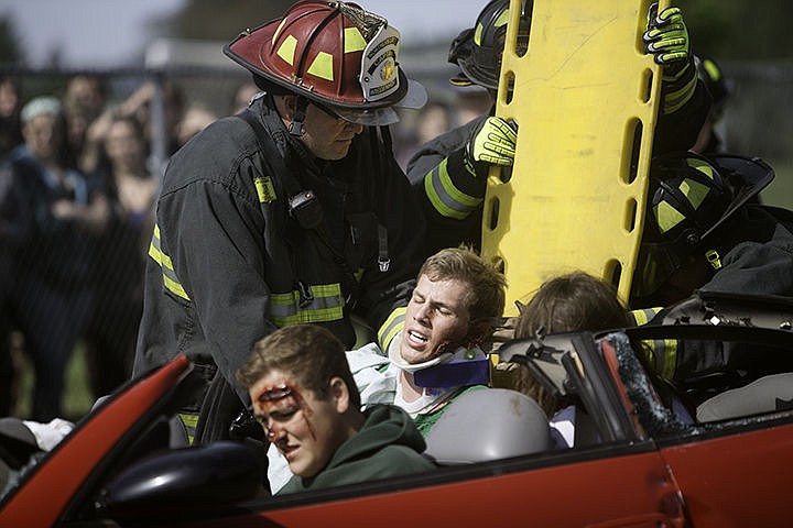 &lt;p&gt;Apart of a driving under the influence re-enactment, Tyrel Derrick, a senior at Lakeland High School is lifted onto a backboard on Main Street in Rathdrum Friday.&lt;/p&gt;