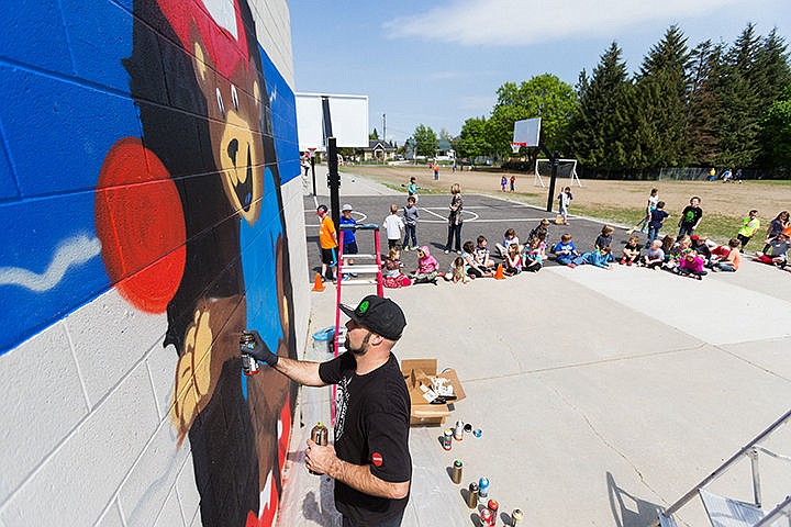 &lt;p&gt;Jeremy Deming, resident artist with ArtCoLab, paints a mural of Bryan Elementary&#146;s mascot on the wall of the wall ball court on the Coeur d&#146;Alene school&#146;s playground on Friday. Deming, who has a student at the school, donated his time and supplies for the project.&lt;/p&gt;