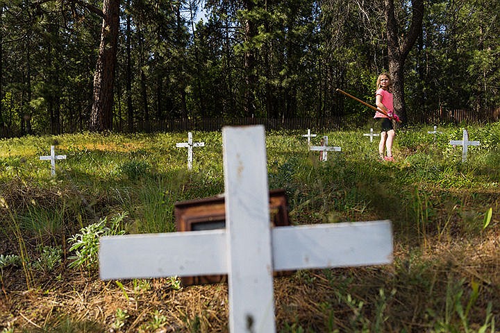 &lt;p&gt;Ashlynn Sullivan, 9, pauses while raking pine needles during a clean-up project at the Kootenai County Cemetery Monday near Seltice Way in Post Falls. Members of the Pine Tree 4-H club and their families, about 40 in total, helped in the effort that has been taking place annually since 1976.&lt;/p&gt;