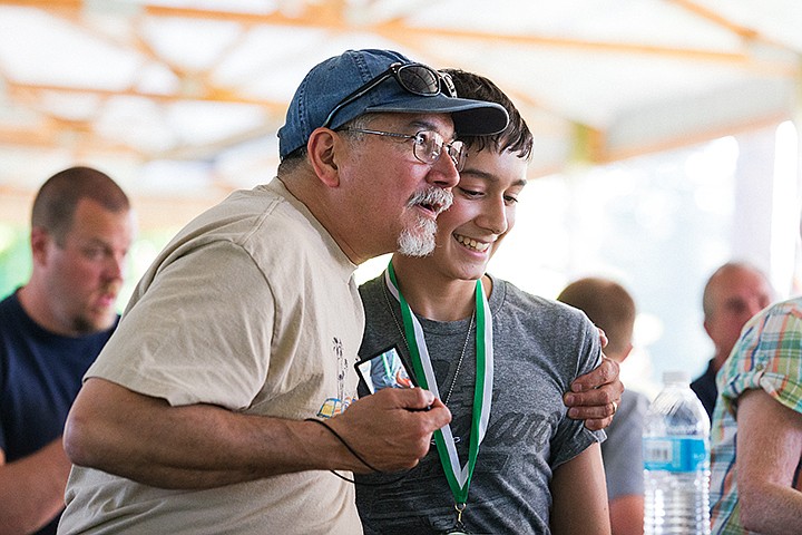 &lt;p&gt;SHAWN GUST/Press&lt;/p&gt;&lt;p&gt;Mike Cuentas hugs his son Sam, 14, after the teen was awarded a plaque in the 12-14 age group of the 2014 Clay Larkin Mayor&#146;s Youth Awards Thursday at Q&#146;emiln Park in Post Falls.&lt;/p&gt;