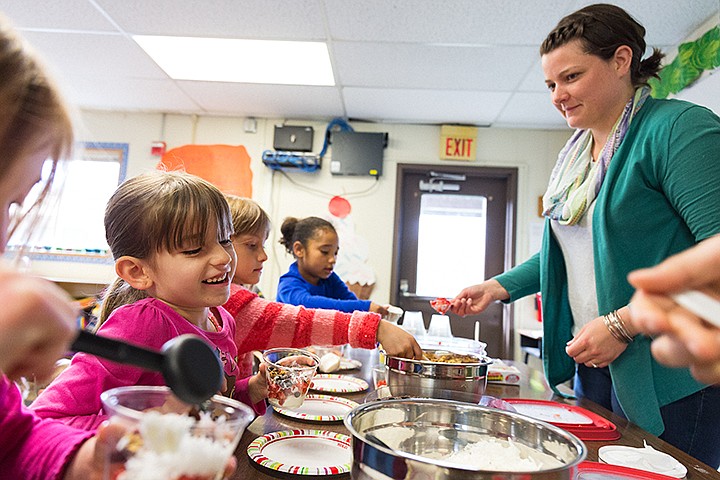 &lt;p&gt;SHAWN GUST/Press&lt;/p&gt;&lt;p&gt;Brooklyn Lininger, a kindergarten at Borah Elementary School, smiles while making a yogurt parfait Friday as University of Idaho nutrition advisor Tessa Holton, right, helps the class portion their snacks during the Eat Smart Idaho program at the school. The program, funded by ConAgra Foods at the state level, promotes good eating habits through education. Parents of Borah students are invited to attend A Night of Nutrition and Fun event from 5:30 p.m. to 7:30 p.m. on Thursday, May 15 at the Coeur d&#146;Alene school.&lt;/p&gt;