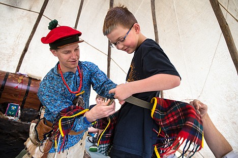 &lt;p&gt;GABE GREEN/Press&lt;/p&gt;&lt;p&gt;Local American Indian enthusiast Andy Meuller, left, dresses Jaden Taylor, 10, in tribal attire Thursday during Ponderosa Elementary's Pat Triphaun Rendezvous. The Western-themed event for fourth-graders featured hands-on exhibits such as archery, wood cutting, and horse riding.&lt;/p&gt;