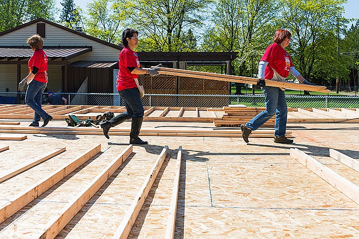 &lt;p&gt;SHAWN GUST/Press&lt;/p&gt;&lt;p&gt;Trudy Elliot, right, leads Lea Williams while carrying lumber Wednesday on the job site of the 7th Annual National Women Build Week. Approximately 50 local women participated in the Habitat for Humanity project in Coeur d&#146;Alene that will continue through May 11.&lt;/p&gt;