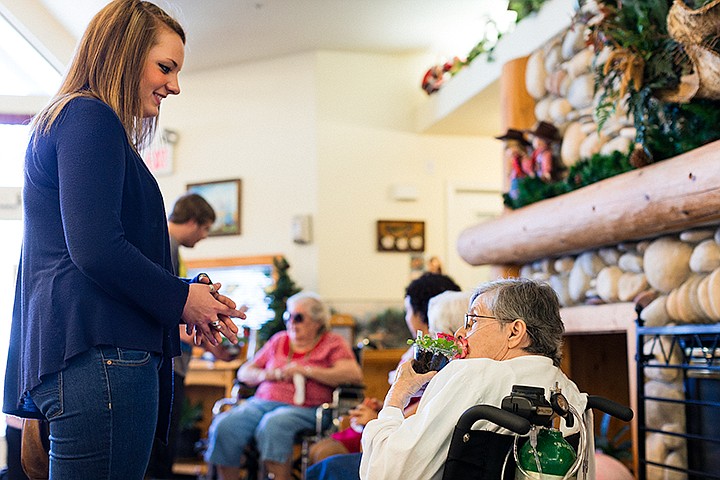 &lt;p&gt;SHAWN GUST/Press&lt;/p&gt;&lt;p&gt;Emogene Bessette, 95, smells a small planter of flowers after receiving them from Sky Lehti, a sophomore at New Vision Alternative High School, Thursday at Guardian Angel Homes in Post Falls. Student handed out flowers, that were grown in the school greenhouse, hand made craft flowers and candies as part of May Day.&lt;/p&gt;