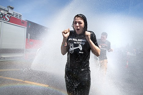 &lt;p&gt;GABE GREEN/Press&lt;/p&gt;&lt;p&gt;Anna Delfakis winces while walking through a blast of water from a Northern Lakes firetruck Wednesday in the parking lot of Lakeland High School. The Northern Lakes Fire Department enlisted the help of 60 lakeland students for a training exercise demonstrating how to respond to a a chemical, biological, radiological, nuclear, and/or explosive hazard. Students were instructed to remove their outer clothing which was placed in plastic bags, then they proceeded to be &#147;decontaminated&#148; by a deluge from firetrucks before putting on a disposable jumpsuit and returning to class.&lt;/p&gt;