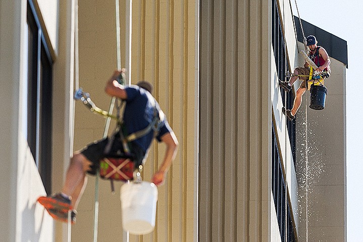 &lt;p&gt;SHAWN GUST/Press&lt;/p&gt;&lt;p&gt;Greg Keeny, with Rainbow Window Cleaning, Inc., right, squeezes water from a cleaning tool Friday as he and co-worker David Sandvik wash the windows on the 18-story Lake Tower Apartments building in Coeur d&#146;Alene.&lt;/p&gt;