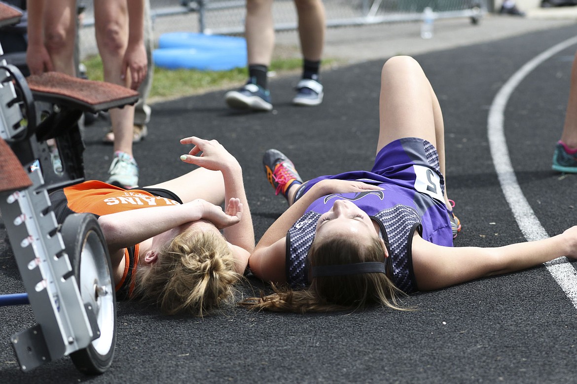 &lt;p&gt;Charlo&#146;s Brooklyn Foust and Plains&#146; Kim Earhart lay next to each other on the track after completing the two mile race at the state track meet.&lt;/p&gt;&lt;p&gt;&lt;strong&gt;&#160;&lt;/strong&gt;&lt;/p&gt;