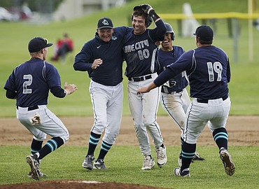 <p>LOREN BENOIT/Press Lake City's Brandon Stapleton (10) celebrates his walk-off RBI ground-rule double with coach Paul Manzardo, middle, Kodie Kolden (2) Dominic Conigliaro (19) and Kaleb Reid (12) during the 5A Region 1 Championship game against Post Falls on May 10, 2016.</p>