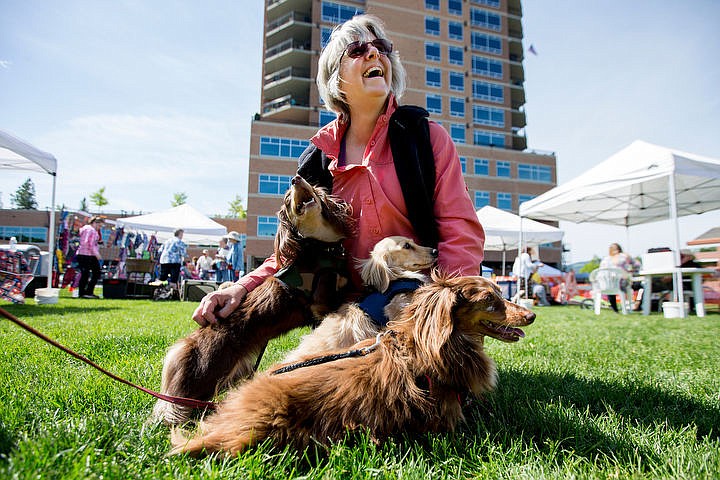 &lt;p&gt;Colleen Anderson of Medical Lake laughs as she recieves some puppy love from her resuced long-haried Dachshunds Miss Twiggy, Ginger and Widget on Saturday, May 14, 2016 at the eighth annual Dog d'Alene in Coeur d'Alene.&lt;/p&gt;