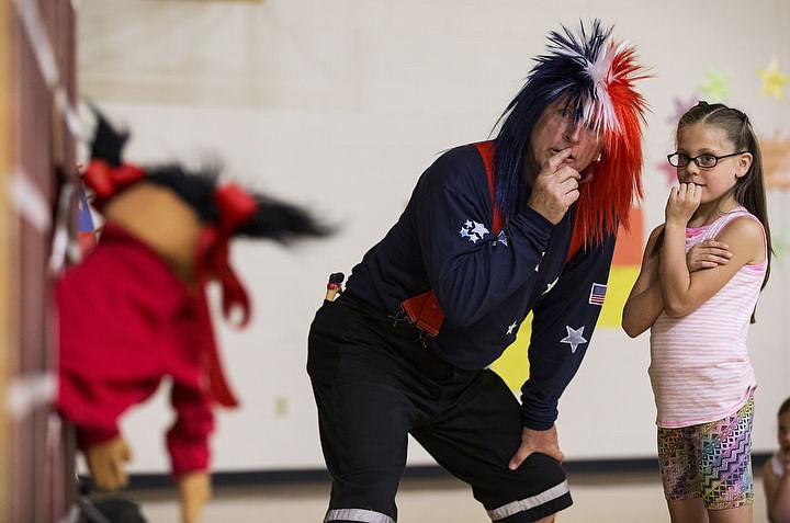 &lt;p&gt;LOREN BENOIT/Press Jim Lyon of Northern Lakes Fire District and first-grader Eden Genkins listen to Katie the puppet give an answer to a Fire Safety Showdown question on Wednesday May 11, 2016 at Borah Elementary School. Lyon, along with other local agencies, will visit 24 local schools the next week to teach 1,700 kids about fire safety and prevention.&lt;/p&gt;