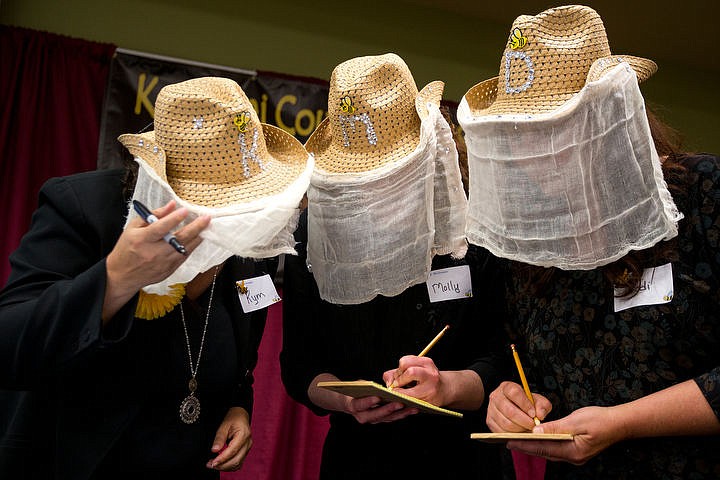 &lt;p&gt;With bee-keeping fabric covering their faces, Kym Browning, Molly Michaud and Dodi Rode of the &quot;Bee-Dazzled&quot; adult spelling bee team work together to determine the spelling of a word on Thursday, May 26, 2016 at the Kootenai County Adult Spelling Bee at North Idaho College.&lt;/p&gt;