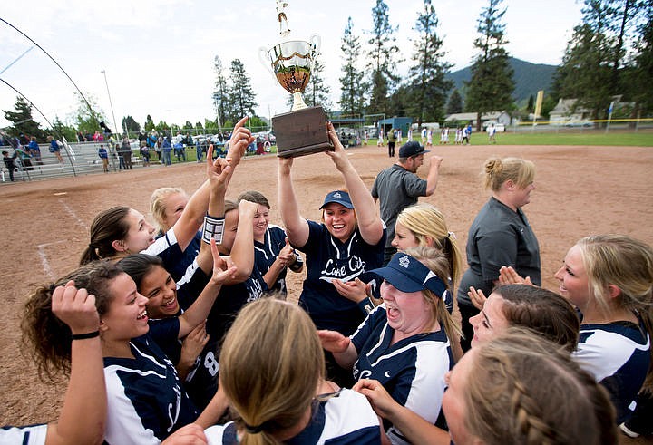 &lt;p&gt;Surronded by teammates, Lake City's Michaela Flerchinger holds up the 5A Division 1 Championship softball trophy after trumping undfeated Coeur d'Alene on Tuesday, May 10, 2016 at Coeur d'Alene High School. Lake City will advance to the state tournament next Friday at Bonneville High School in Idaho Falls.&lt;/p&gt;