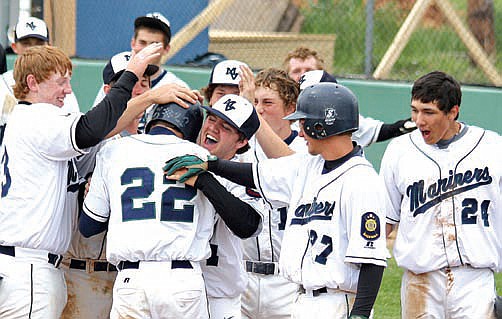 Kevin Hagedorn gets mobbed by teammates after hitting a home run against Libby.