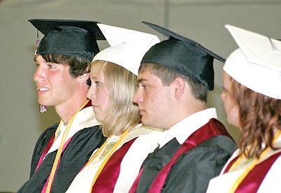 Canda Harbaugh/The Western News Aaron Palmer, left, sits among his classmates on Saturday during Troy High School&#146;s graduation. Palmer will be headed to Harvard University this fall.