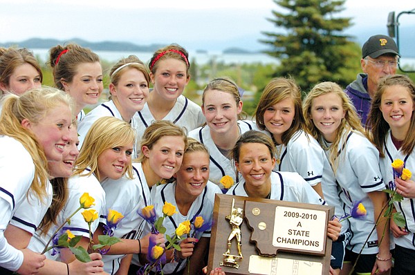 The Polson softball team takes time for a team photo with their championship trophy.