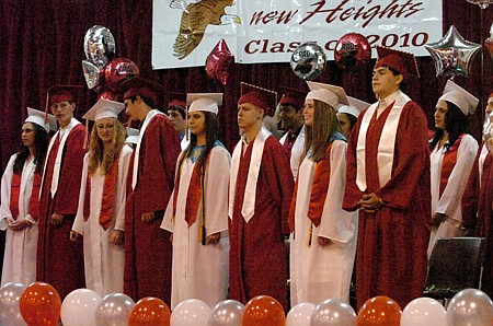 The graduates stand during the opening ceremony.