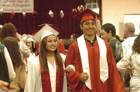 Deidra Joseph and Kyle Felsman take the walk after graduation.